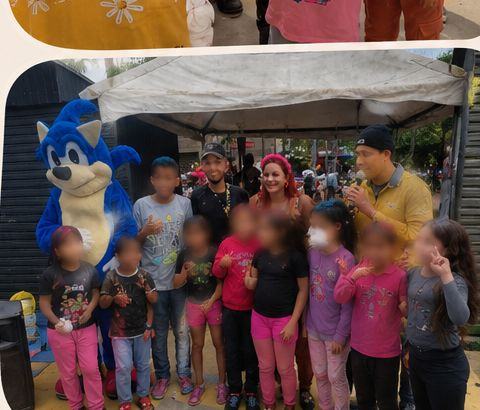 Lolo em foto de grupo com crianças e mascote em evento